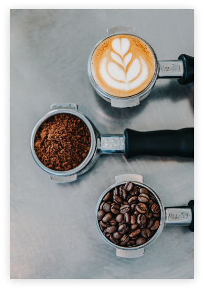 coffee in a mug aside coffee powder, and coffe beans