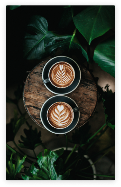 Two beautifully shot coffee mugs with coffee in them